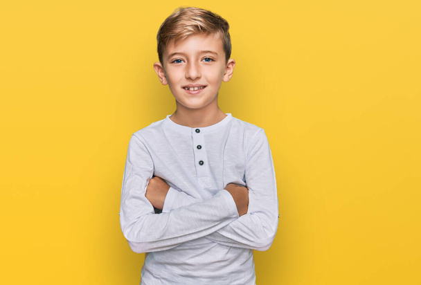 Little caucasian boy kid wearing casual clothes happy face smiling with crossed arms looking at the camera. positive person.  - Photo, Image
