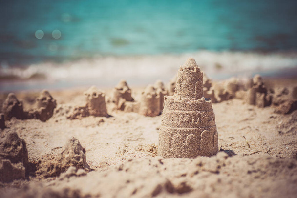 Sand castle standing on the beach. Travel vacations concept. - Photo, Image