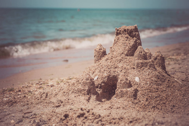 砂浜に立つ砂の城。旅行休暇のコンセプト. - 写真・画像
