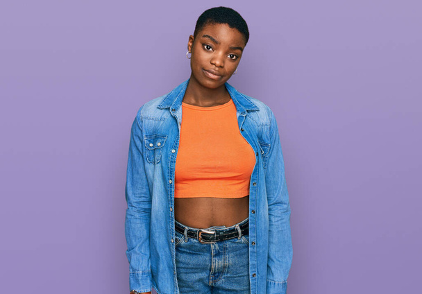 Young african american woman wearing casual clothes looking sleepy and tired, exhausted for fatigue and hangover, lazy eyes in the morning.  - Photo, Image