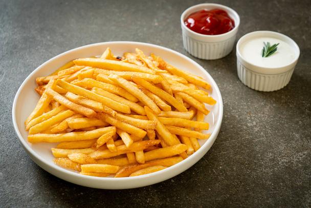 French fries or potato chips with sour cream and ketchup - Φωτογραφία, εικόνα