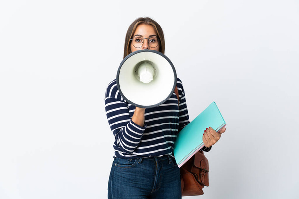 fiatal diák nő elszigetelt fehér háttér kiabál keresztül egy hangosbeszélő - Fotó, kép