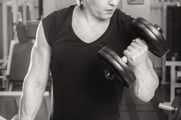 Man doing workout with heavy dumbbell - Fotoğraf, Görsel