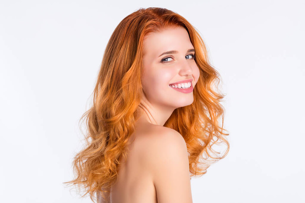 Side profile photo portrait of girl with curly red hair laughing happy with naked shoulders isolated white color background - 写真・画像