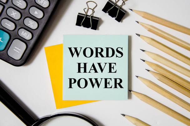 Words Have Power text written on a white notepad with colored pencils and a yellow background - Foto, imagen