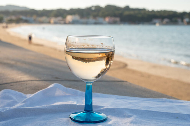 Summer time in Provence, drinking of cold dry gris rose wine on sandy beach and blue sea near Toulon, Var department, France - Photo, Image