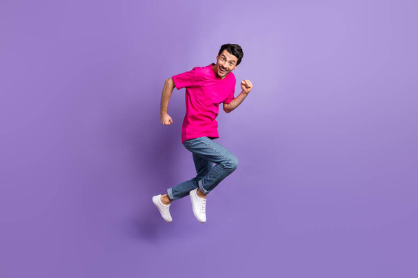 Full length profile portrait of excited person running toothy smile look camera isolated on purple color background - Fotó, kép