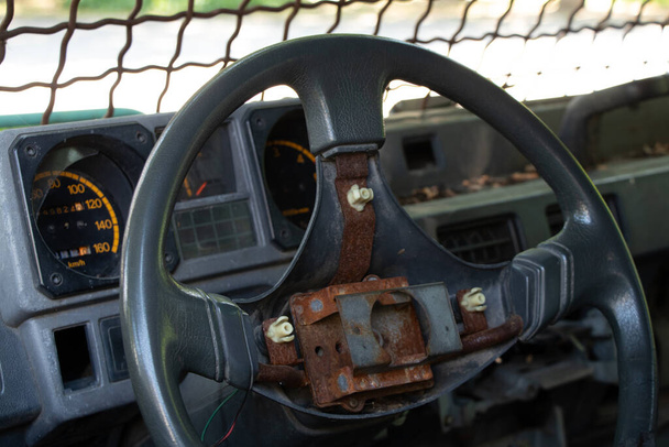 старый сломанный военный автомобиль с решетками на переднем окне, автомобиль после прохождения военных действий, авто - Фото, изображение
