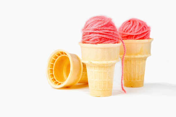 Pink yarn balls in ice cream cones isolated on white background - Foto, Imagem