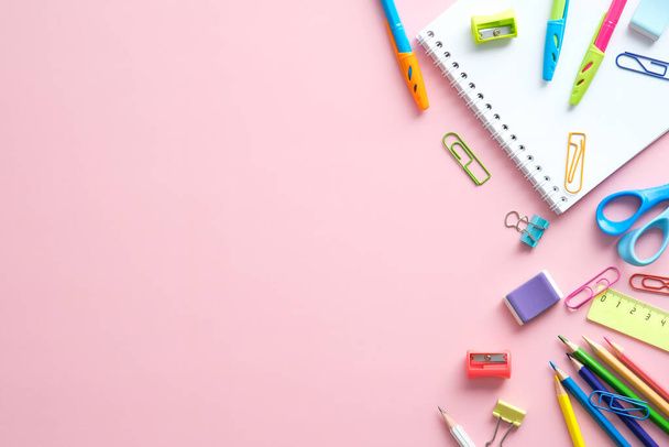 School supplies on pink background. Back to school creative flat lay. - Foto, afbeelding