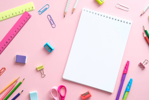 Flat lay school supplies and paper notebook on pink background. Back to school concept. - Valokuva, kuva
