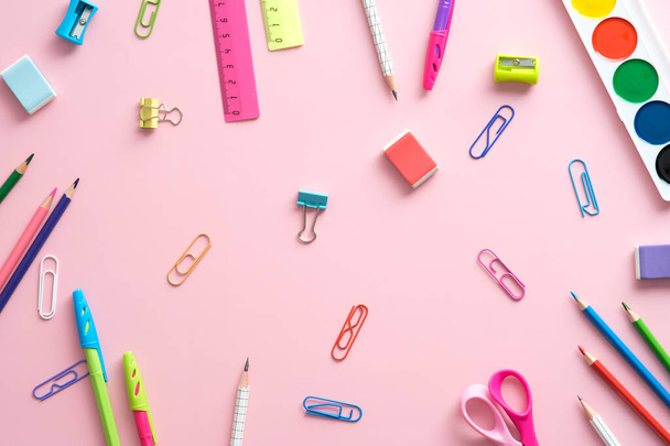 School supplies on pink background top view. Creative layout with school stationery. Back to school concept. Flat lay. - Foto, imagen