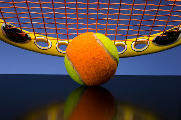 Tennis Ball for children with tennis racket on blue background - Fotó, kép
