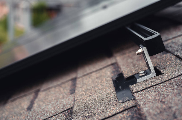 Rail, bracket, and anchor to a solar panel installed on a asphalt shingle roof - Foto, imagen