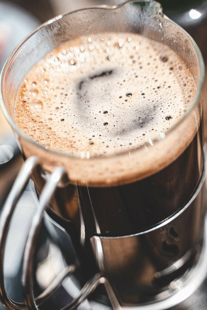 A vertical shot of gourmet coffee in a french press - Photo, image