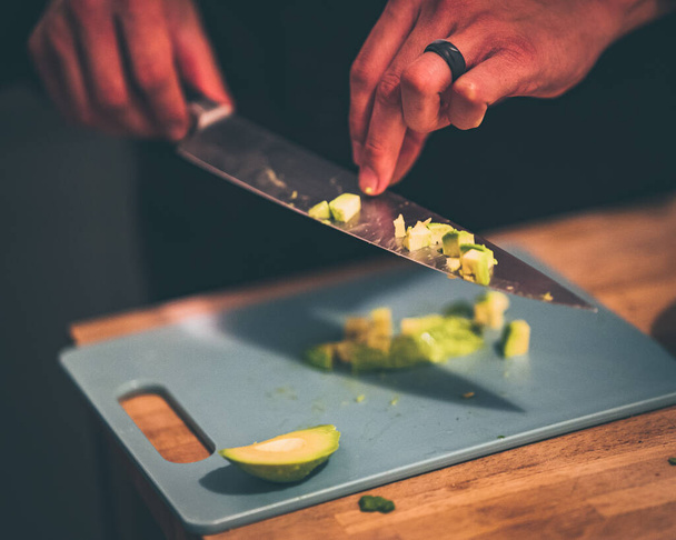 A closeup shot of a gourmet chef cutting a green vegetable - 写真・画像