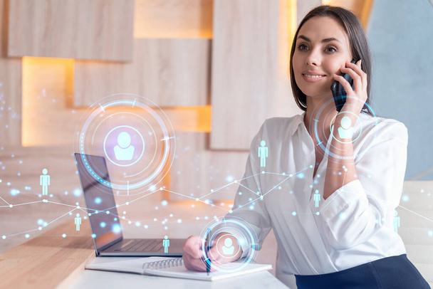Attractive businesswoman in white shirt has conference call to hire new employees for international business consulting. HR, social media hologram icons over office background - Fotoğraf, Görsel