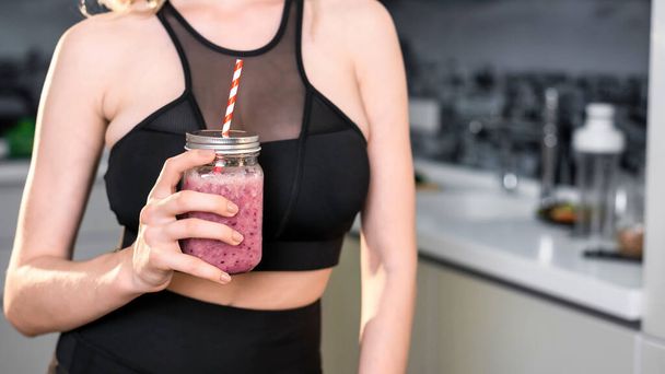 Young woman holding a healthy smoothie drink - Photo, Image