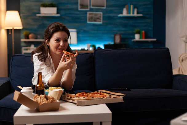 Caucasian female holding delicious pizza slice eating takeaway food delivery - Fotoğraf, Görsel