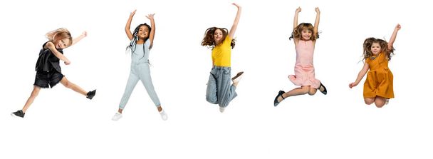 Art collage made of little and happy kids jumping isolated on white studio background. Human emotions, facial expression concept - Photo, image