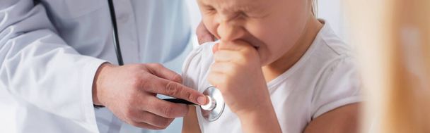 Kid sneezing near doctor with stethoscope, banner  - Photo, Image