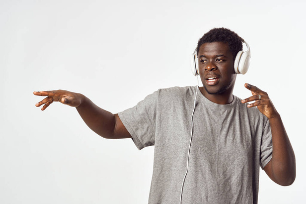 Cheerful man of African appearance in headphones listens to music - Photo, Image