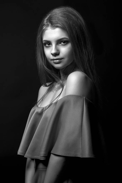 Studio monochrome portrait of a glamor young woman posing with naked shoulders - Valokuva, kuva