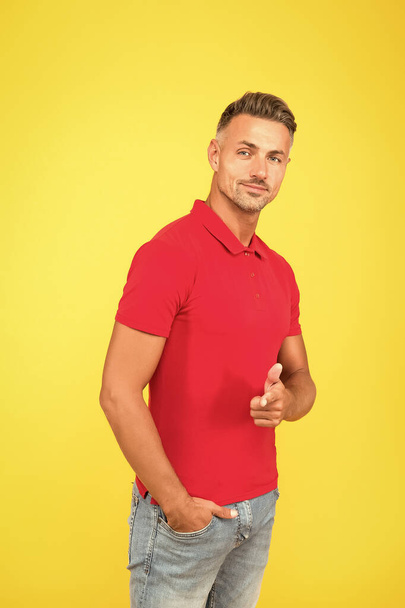 Would you like. Handsome man point finger yellow background. Promoting and marketing. Promoting menswear shop. Advertising new fashion label. Mens wear - Valokuva, kuva