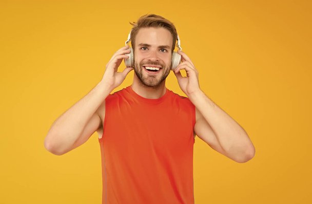 happy young man athlete in sport wear and headset listen music while exercising, happiness - Фото, изображение