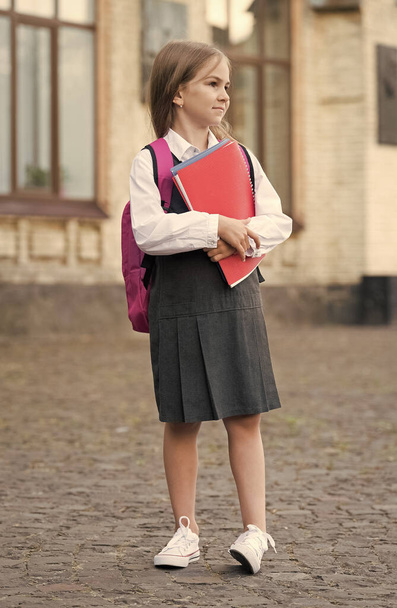 Good things are happening here. Little child go to lyceum school. Lyceum student hold books outdoors. Back to school supplies. Compulsory education. Knowledge day. September 1. Private teaching - 写真・画像