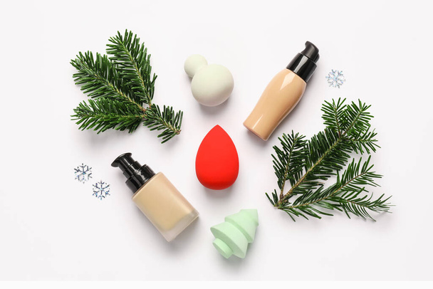 Christmas composition with makeup sponges and tonal foundation on white background - Φωτογραφία, εικόνα