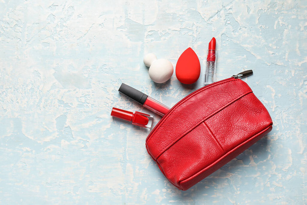 Bag with makeup supplies on light background - Фото, изображение