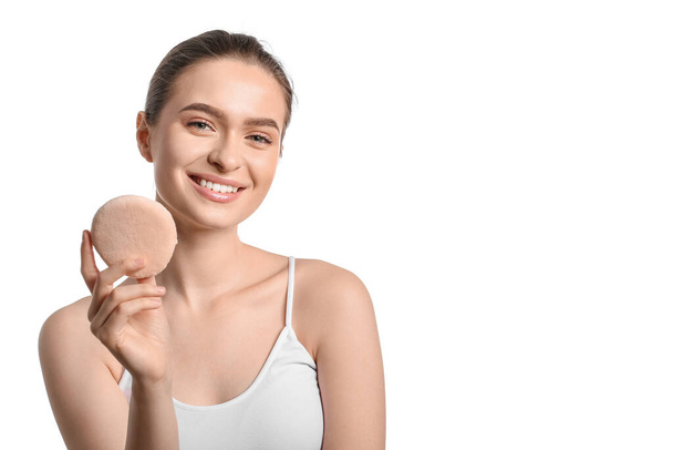 Beautiful young woman with makeup sponge on white background - Photo, Image