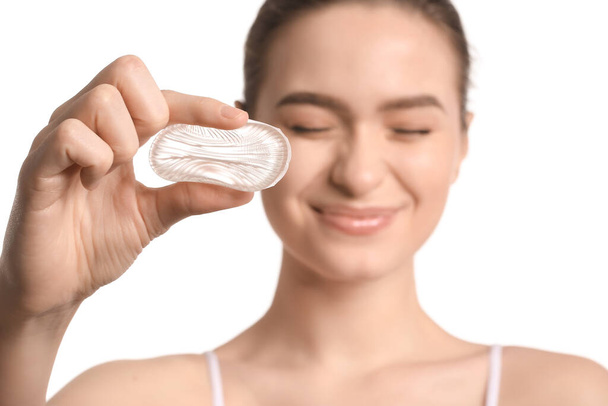 Beautiful young woman with makeup sponge on white background - Φωτογραφία, εικόνα