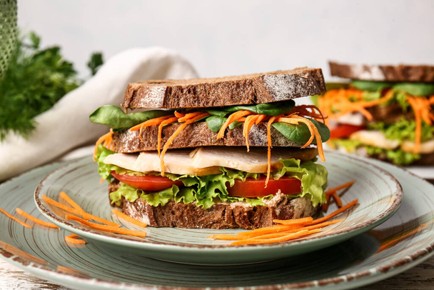 Plate with tasty sandwich on light background, closeup - Fotó, kép