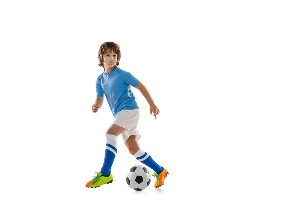 Young sportsman, football soccer player, child playing football isolated on white studio background. Concept of sport, game, hobby - Foto, immagini