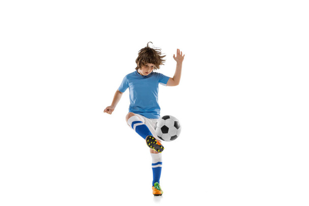Young male football soccer player, boy training with football ball isolated on white studio background. Concept of sport, game, hobby - Foto, immagini