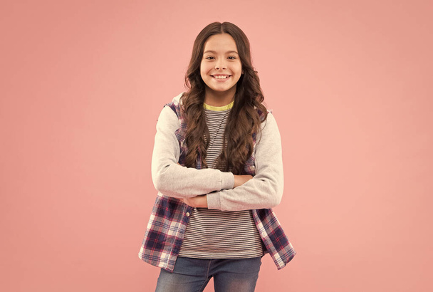 She is really cute. Happy child smile pink background. Beauty look. Little girl child in casual style. Fashion trend. Trendy style. Child care and childhood. International childrens day - Photo, Image