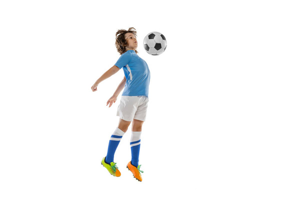 Portrait of little male football soccer player, boy training with football ball isolated on white studio background. Concept of sport, game, hobby - Fotó, kép