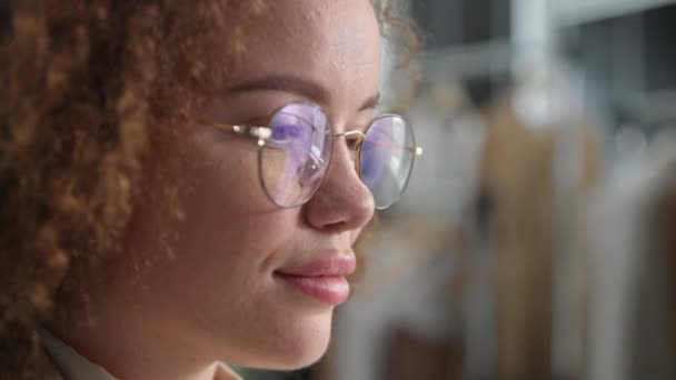 retrato de uma jovem mulher com óculos para visão usa tecnologias modernas e olha para a tela de um tablet ou computador enquanto trabalha, close-up - Filmagem, Vídeo