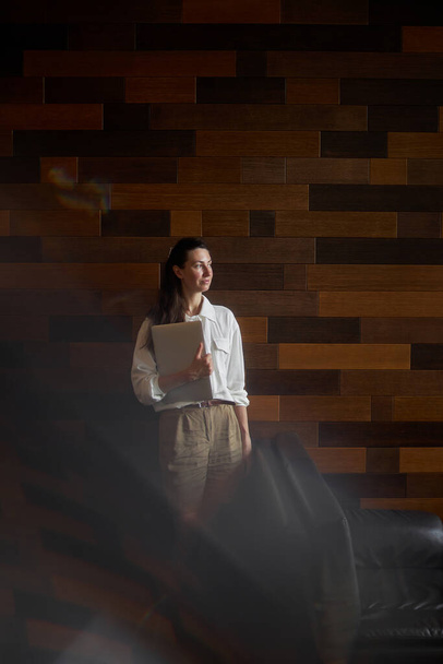Business woman portrait with laptop. She is working and relaxing at a cafe drinking coffee - 写真・画像