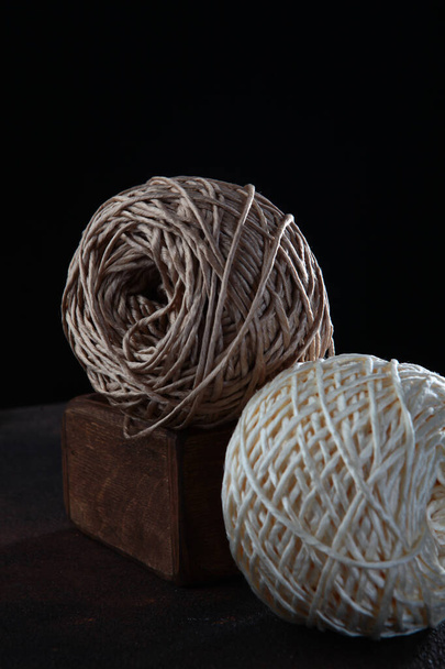 Knitting yarn in wooden box. Knitting with needles. Hobby concept.Vertical photo.Copy space.Side view. - Foto, Imagem
