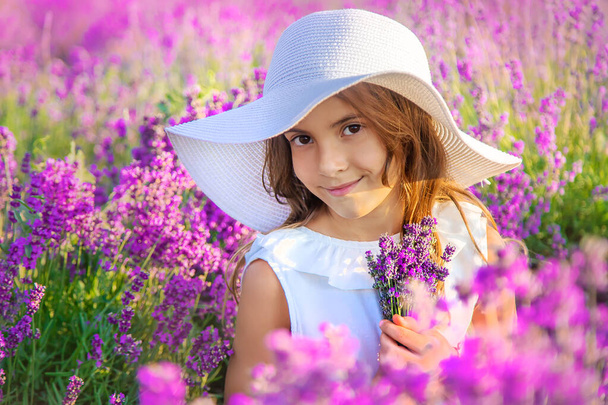 A child in a lavender field. Selective focus. Nature. - Fotoğraf, Görsel