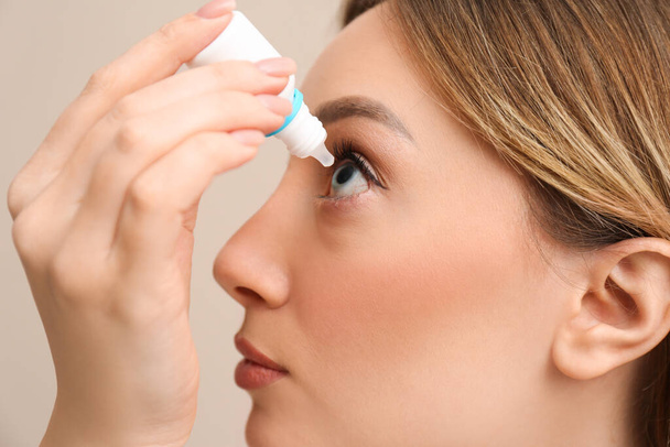 Young woman using eye drops, closeup view - Фото, изображение