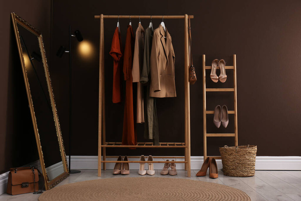 Modern dressing room interior with clothing rack and mirror - Foto, Bild