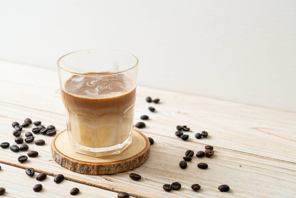 Dirty coffee glass, cold milk topped with hot espresso coffee shot - 写真・画像