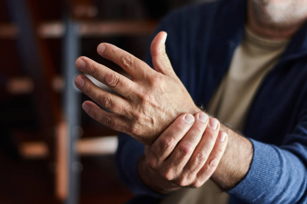 A closeup shot of a middle-aged Caucasian male with osteoarthritis pain - Φωτογραφία, εικόνα