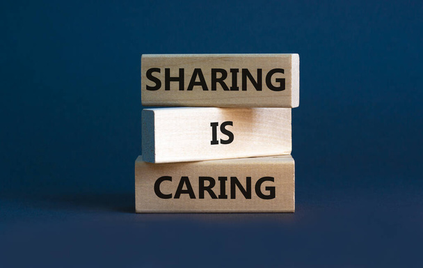 Sharing is caring symbol. Wooden blocks with words 'Sharing is caring' on beautiful grey background. Business, sharing is caring concept. Copy space. - Фото, изображение