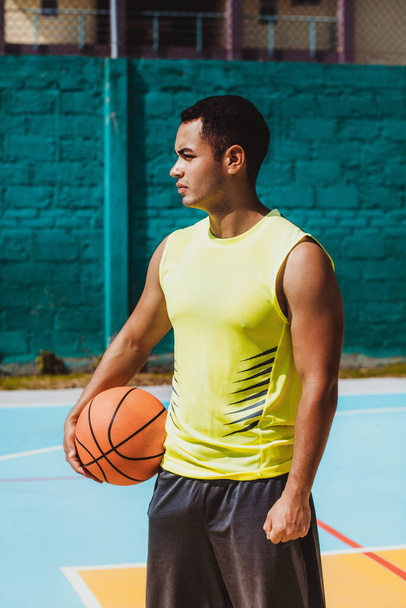 young latin man playing basketball portrait in Mexico - 写真・画像