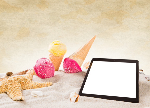 Tasty ice creams with tablet on the beach - Photo, Image